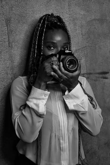 Photographer holding a camera up to the lens